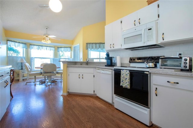 kitchen featuring plenty of natural light, white cabinets, white appliances, and decorative backsplash