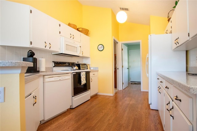 kitchen featuring backsplash, white cabinets, white appliances, and light hardwood / wood-style floors