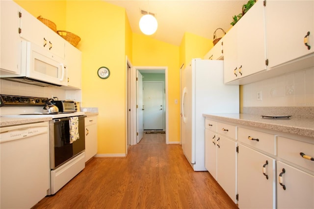 kitchen featuring lofted ceiling, white appliances, light hardwood / wood-style flooring, white cabinetry, and decorative backsplash