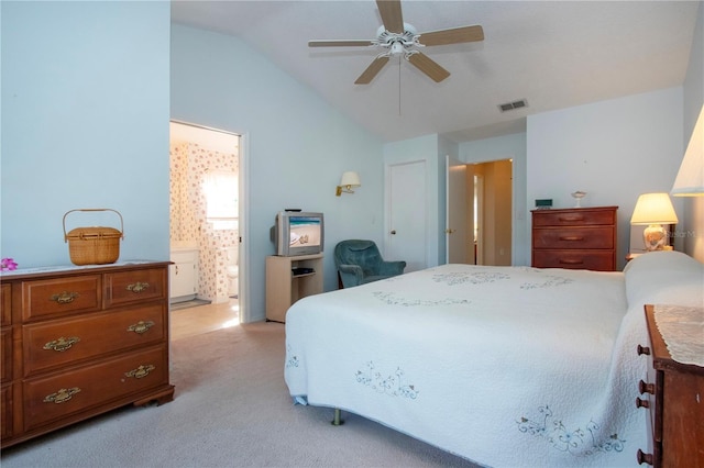 carpeted bedroom featuring ensuite bath, vaulted ceiling, and ceiling fan