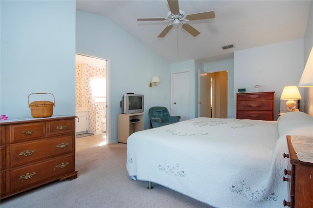 carpeted bedroom with ceiling fan, ensuite bathroom, and vaulted ceiling