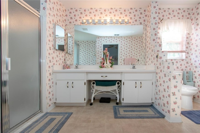 bathroom with vanity, a shower with shower door, tile patterned floors, and toilet