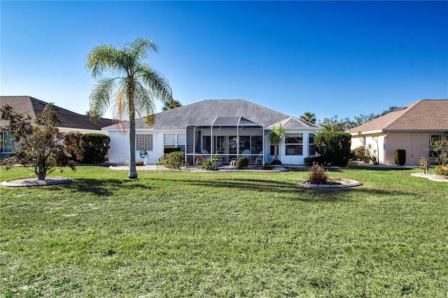 back of property featuring a yard and a lanai