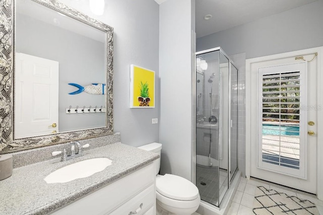 bathroom featuring vanity, an enclosed shower, tile patterned floors, and toilet