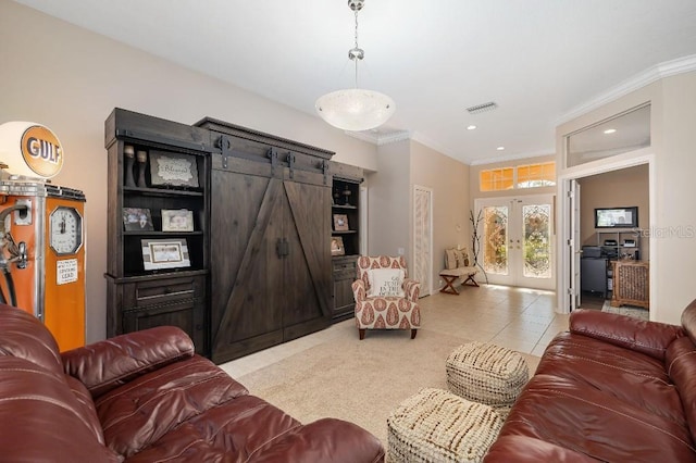 living room with crown molding, a barn door, light tile patterned flooring, and french doors