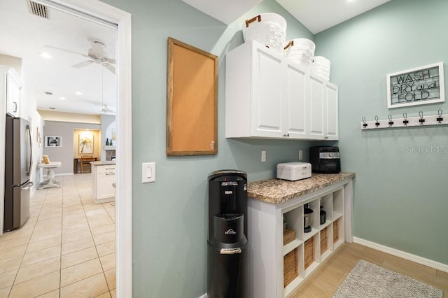 interior space featuring light tile patterned flooring and ceiling fan