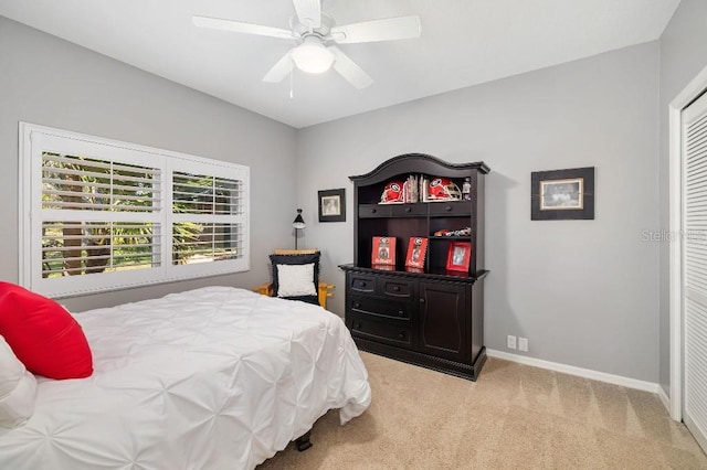 bedroom featuring light colored carpet and ceiling fan