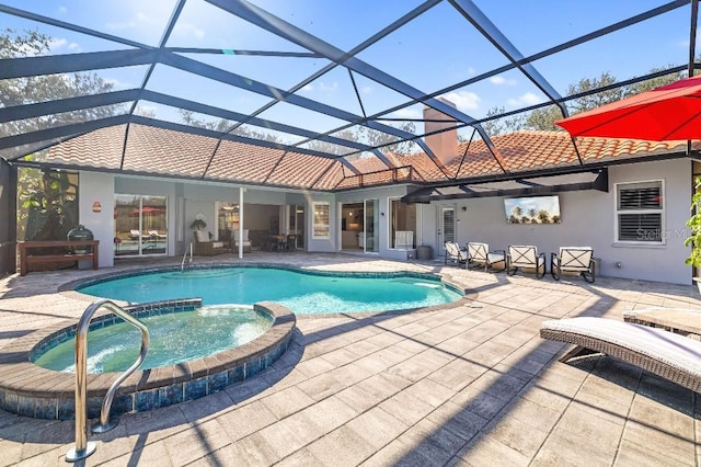 view of swimming pool with a patio, glass enclosure, and an in ground hot tub