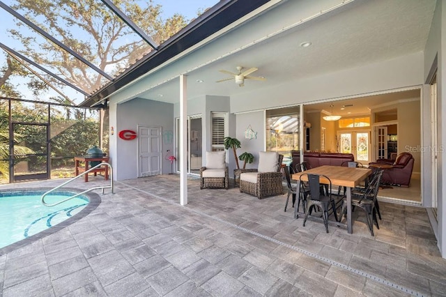 exterior space featuring a lanai, ceiling fan, and a pool with hot tub