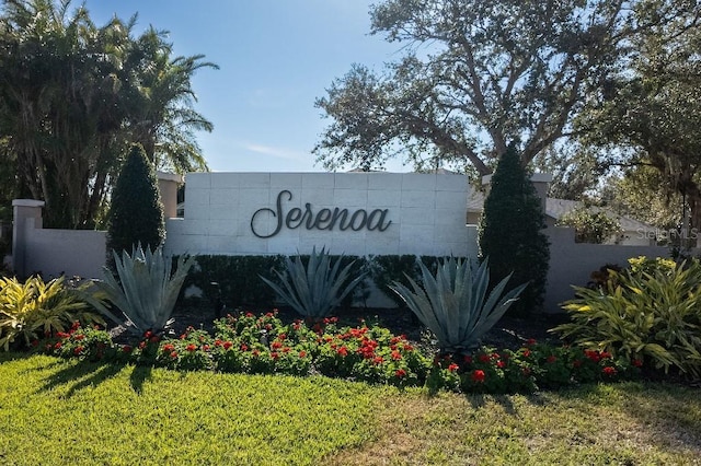 community / neighborhood sign with a lawn