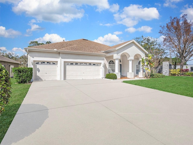 mediterranean / spanish-style home with a garage and a front lawn