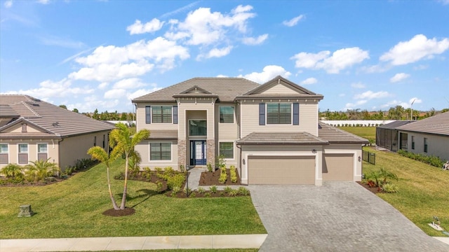 view of front of house featuring a garage and a front lawn