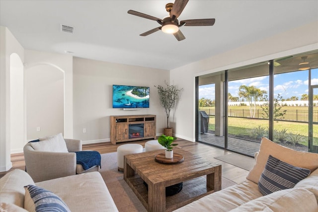 living room featuring ceiling fan and light wood-type flooring