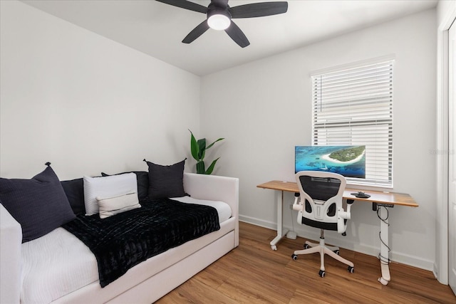 bedroom with hardwood / wood-style flooring and ceiling fan