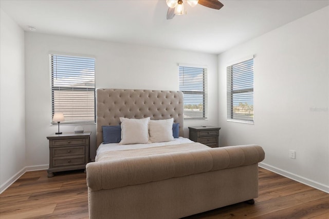 bedroom featuring dark hardwood / wood-style flooring and ceiling fan