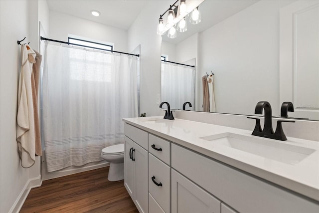 full bathroom featuring vanity, wood-type flooring, shower / bath combo, and toilet