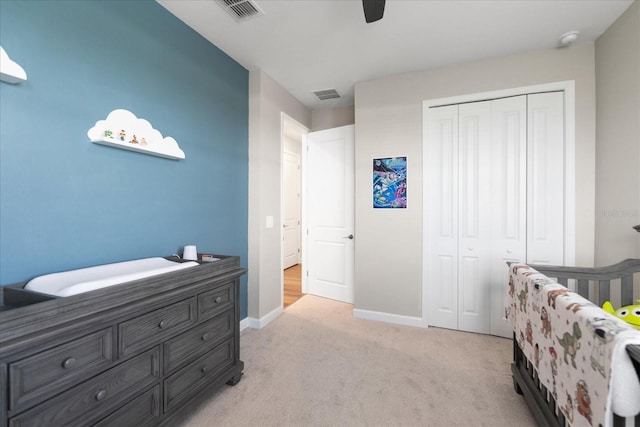 bedroom featuring light carpet, a closet, and ceiling fan