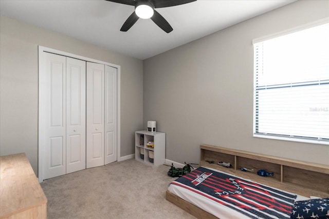 carpeted bedroom with a closet and ceiling fan