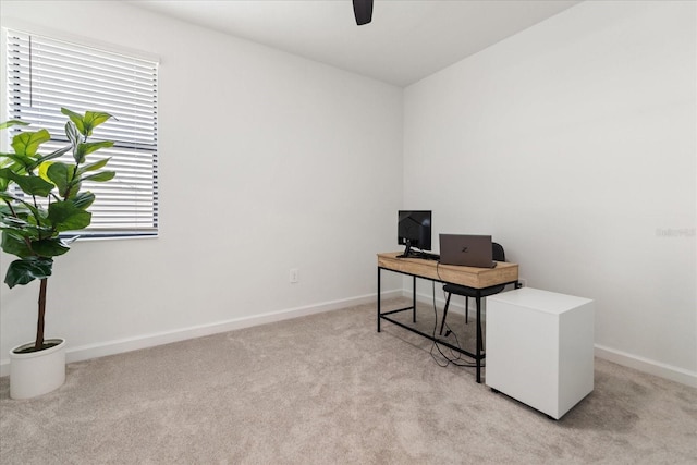 office area featuring ceiling fan and light carpet