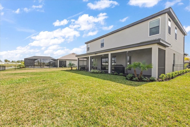 back of property featuring a sunroom and a lawn