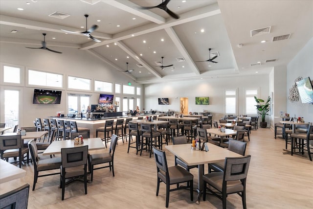 dining room with beamed ceiling, ceiling fan, high vaulted ceiling, and light wood-type flooring