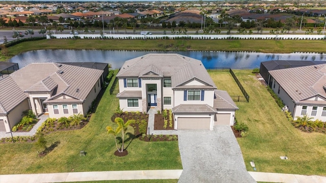 drone / aerial view featuring a water view and a residential view