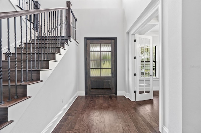 entryway with dark hardwood / wood-style flooring