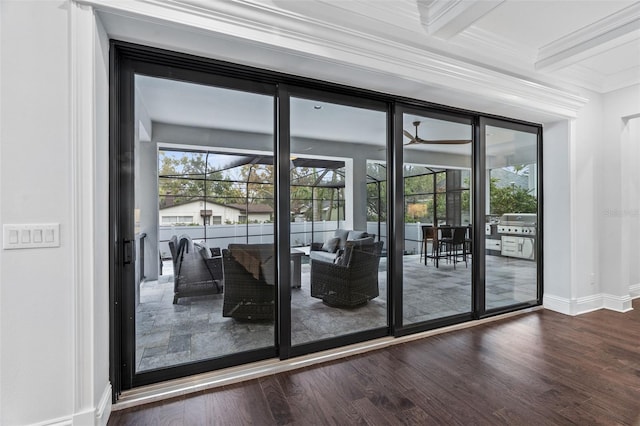 doorway to outside featuring crown molding, dark wood-type flooring, beamed ceiling, and plenty of natural light