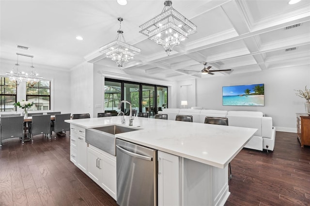 kitchen featuring a kitchen island with sink, decorative light fixtures, and stainless steel dishwasher