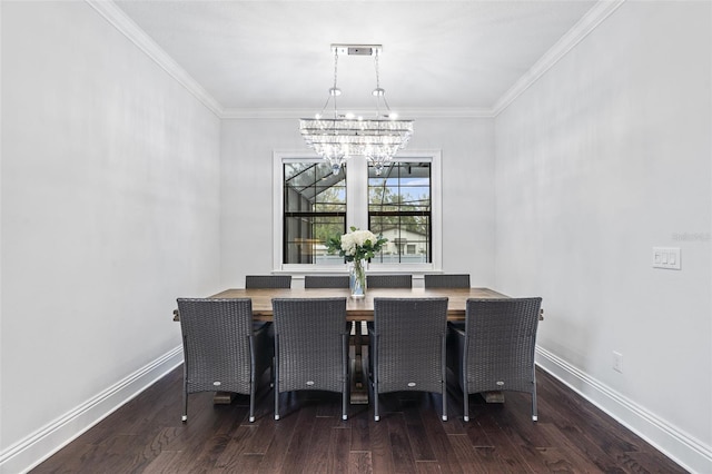 dining area featuring dark hardwood / wood-style flooring, crown molding, and an inviting chandelier