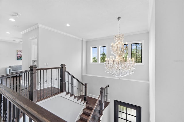 stairway featuring crown molding, a chandelier, and hardwood / wood-style floors