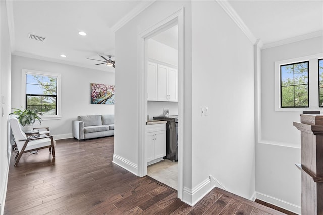 corridor with ornamental molding and dark hardwood / wood-style floors