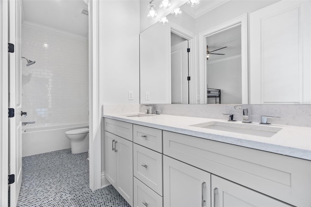 full bathroom featuring tiled shower / bath, ornamental molding, vanity, toilet, and tile patterned floors