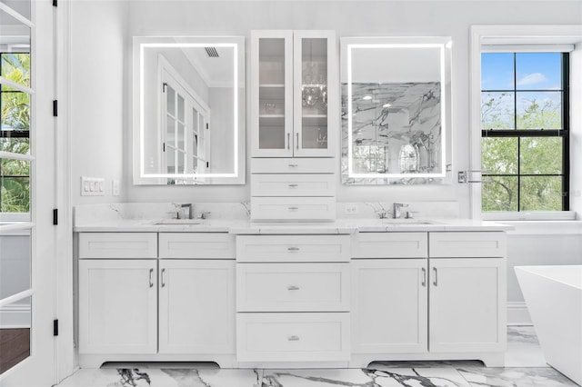 bathroom featuring a tub to relax in and vanity