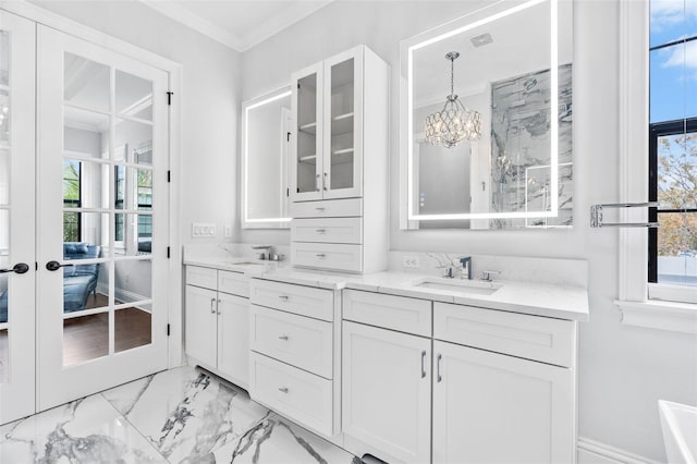 bathroom featuring french doors, ornamental molding, and vanity