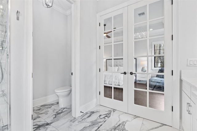 bathroom with french doors, ceiling fan, and toilet