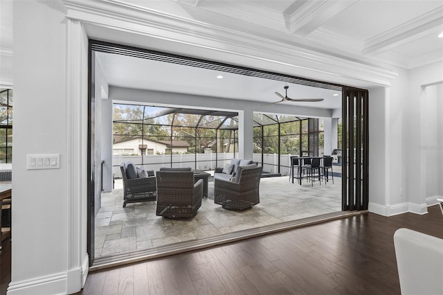 doorway to outside featuring beamed ceiling, ceiling fan, ornamental molding, and hardwood / wood-style floors