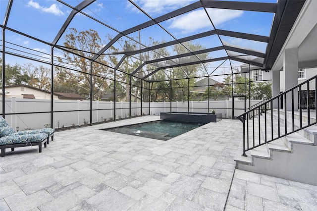 view of swimming pool with a lanai, a patio area, and pool water feature