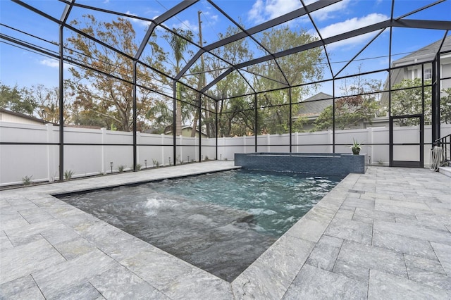 view of pool featuring pool water feature, a patio, and glass enclosure