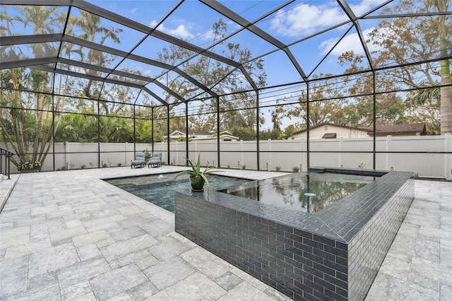 view of pool featuring an in ground hot tub, a lanai, and a patio area