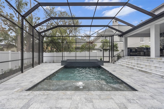 view of swimming pool featuring a lanai and a patio area