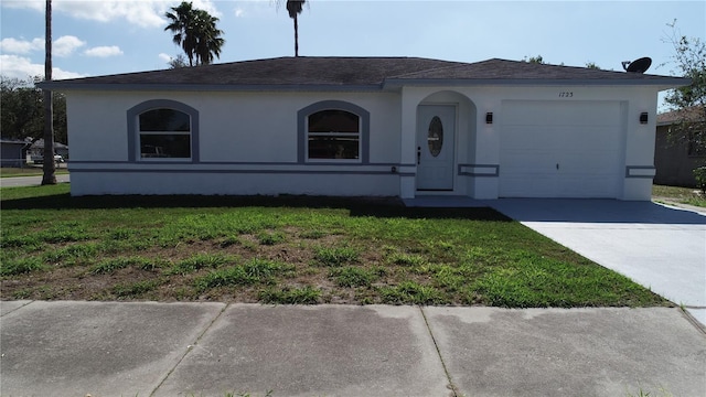 view of front of house featuring a garage and a front lawn