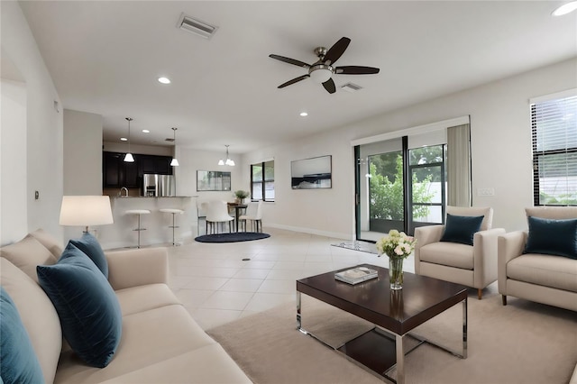 living room with light tile patterned floors and ceiling fan