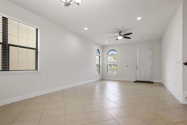 unfurnished room featuring light tile patterned floors and ceiling fan