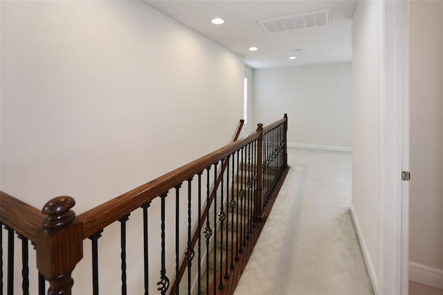 hallway featuring light colored carpet