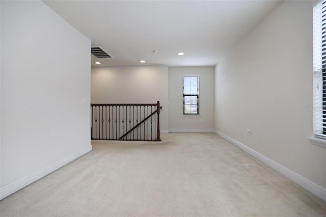 empty room featuring light carpet