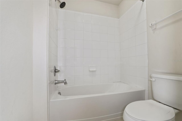 bathroom featuring toilet and tiled shower / bath combo