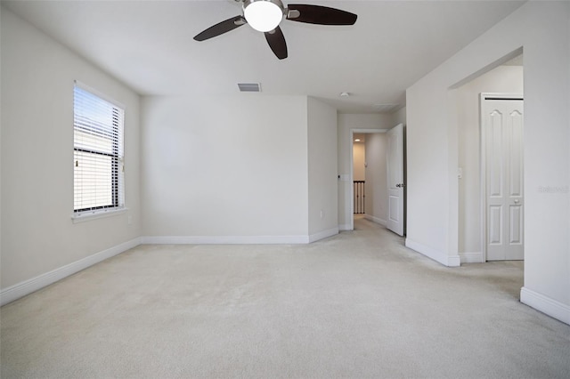 unfurnished room featuring light carpet and ceiling fan