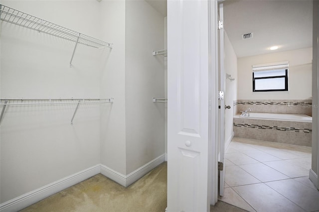 spacious closet with tile patterned floors