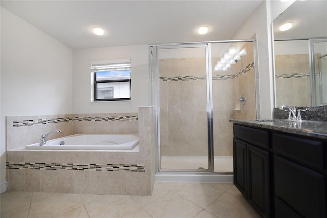 bathroom featuring tile patterned flooring, shower with separate bathtub, and vanity